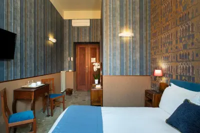 a hotel room with a bed and a table and a desk at Welcome House in Rome