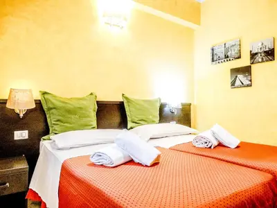 two beds sitting next to each other in a room at B&B Morelli 1 in Rome