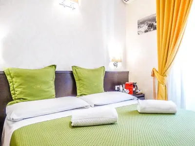a bedroom with a bed with two pillows on it at B&B Morelli 1 in Rome