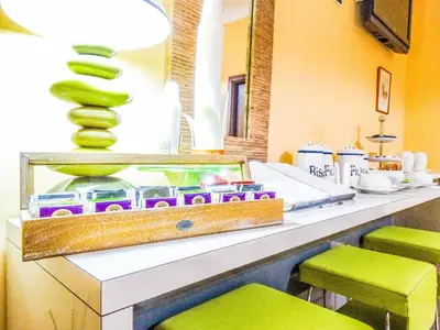 a counter with green stools in a room at B&B Morelli 1 in Rome