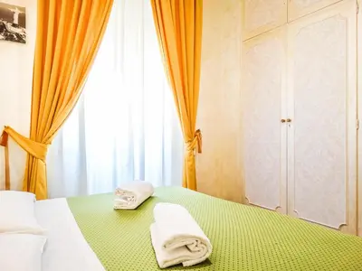 a bedroom with two towels on a bed with a window at B&B Morelli 1 in Rome