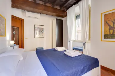 a bedroom with a blue bed with towels on it at Rome as you feel - Panisperna Apartment in Rome