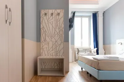 a bedroom with a bed and a painting on the wall at Domus Porta Angelica in Rome