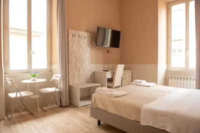 a bedroom with a bed and a table with chairs at Domus Porta Angelica in Rome