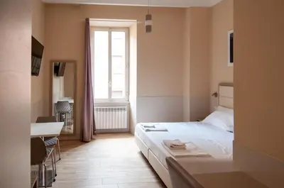 a hotel room with a bed and a window at Domus Porta Angelica in Rome