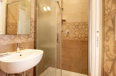 a bathroom with a sink and a shower at Domus Porta Angelica in Rome