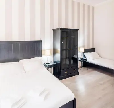 a bedroom with a bed and a chair and a cabinet at Piazza Cavour Suite in Rome