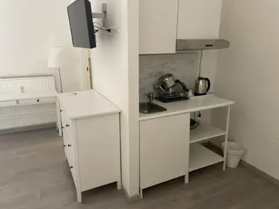 a white kitchen with a counter and a microwave at Piazza Cavour Suite in Rome