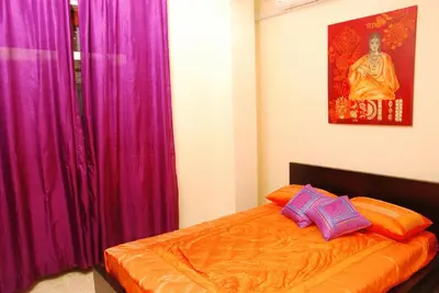 a bedroom with purple curtains and a bed with two pillows at Stefy's Rooms in Rome