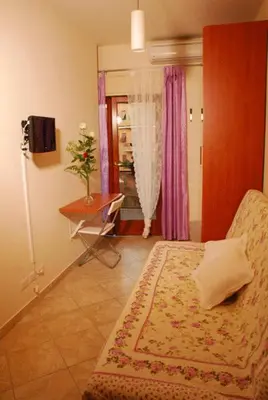 a bedroom with a bed and a table and a window at Stefy's Rooms in Rome