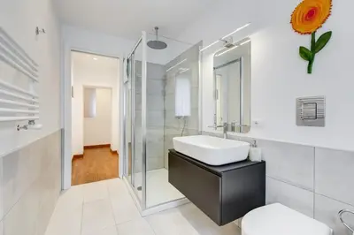 a bathroom with a sink and a glass shower at Piazza Navona-Coronari House in Rome