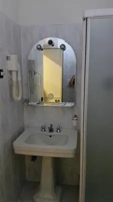 a bathroom with a sink and a mirror at Hotel Croce Di Malta in Rome