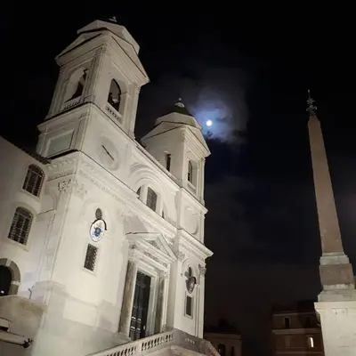 a white building with a moon in the sky at Hotel Croce Di Malta in Rome