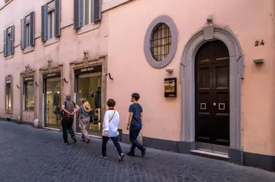 a group of people walking down a street at Les Fleurs Luxury House in Rome