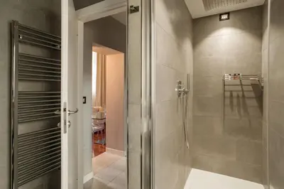 a shower with a glass door in a bathroom at Les Fleurs Luxury House in Rome