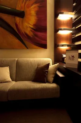a couch in a room with a painting on the wall at Les Fleurs Luxury House in Rome