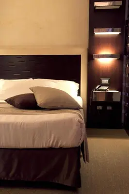 a bedroom with a large bed with a black headboard at Les Fleurs Luxury House in Rome