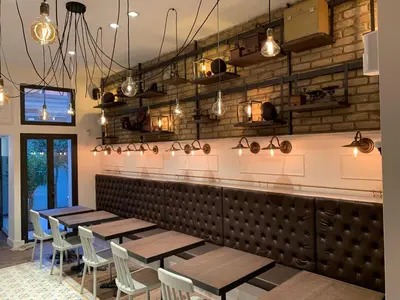 a restaurant with wooden tables and chairs and lights at Les Fleurs Luxury House in Rome