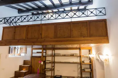 a room with a large wooden ceiling and shelves at Behind Navona in Rome