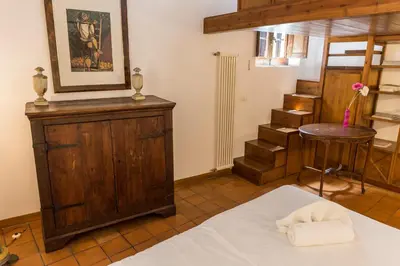 a room with a bed and a table and a stool at Behind Navona in Rome