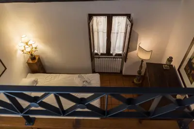 a bedroom with a bed and a window and a table at Behind Navona in Rome