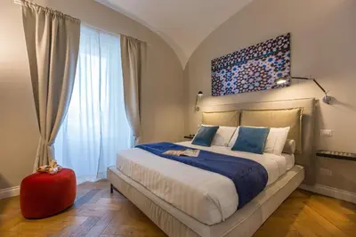 a bedroom with a large bed and a large window at Palazzo Baj in Trastevere in Rome