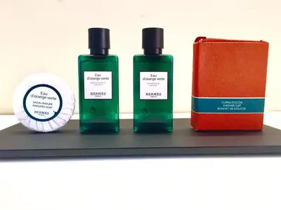 a shelf with two bottles of soap and a notebook at Palazzo Baj in Trastevere in Rome
