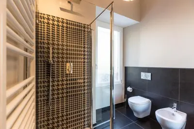 a bathroom with a shower and a toilet and a sink at Palazzo Baj in Trastevere in Rome