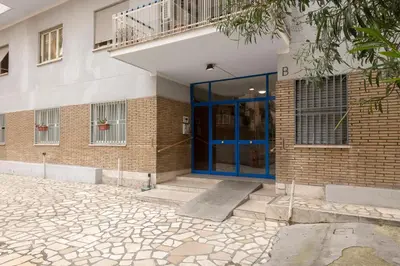 a brick building with a blue door on it at Aurelia Home Guest House in Rome