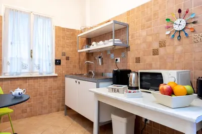 a kitchen with a counter with fruit on it at Aurelia Home Guest House in Rome
