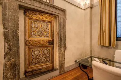 a wooden door in a room with a glass table at Magenta Collection Specchi in Rome