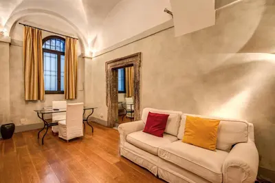 a living room with a white couch with two colorful pillows at Magenta Collection Specchi in Rome