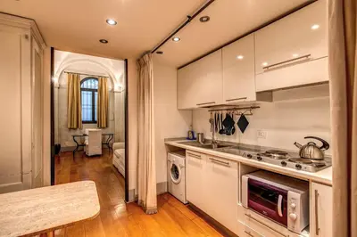 a kitchen with a sink and a stove top oven at Magenta Collection Specchi in Rome