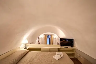 a bedroom with a bed and a tv in a room at Magenta Collection Specchi in Rome