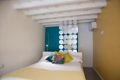 a bedroom with a bed with a white ceiling at Secret Rhome Loft in Rome
