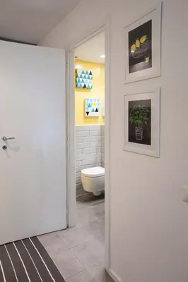 a bathroom with a toilet and a white door at Secret Rhome Loft in Rome