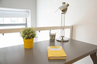 a desk with a lamp and a book on it at Secret Rhome Loft in Rome