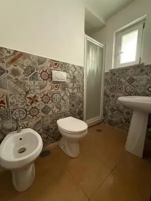 a red bed with two towels on top of it at Clarian Affittacamere in Rome