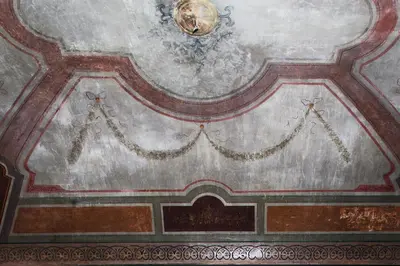a ceiling in a building with a painting on it at Casa de' Coronari Suites in Rome