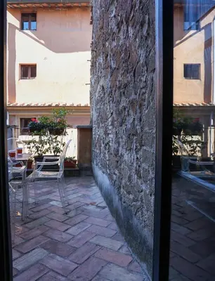 a view of a patio with chairs and a building at Casa de' Coronari Suites in Rome