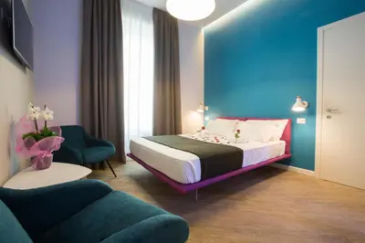 a bedroom with a bed and a blue wall at Ara Suite in Rome