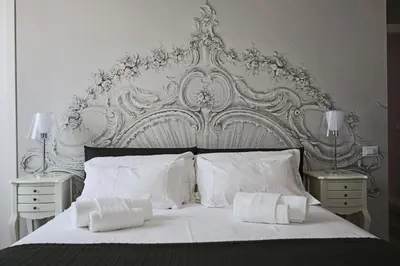 a white bed with two nightstands and two lamps at Ara Suite in Rome