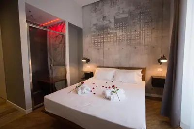 a bedroom with a white bed with flowers on it at Ara Suite in Rome