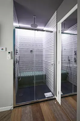 a bathroom with a shower with a glass door at Ara Suite in Rome