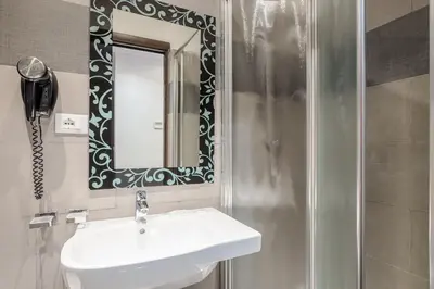a bathroom with a sink and a mirror at Imperial Suite Guest House in Rome