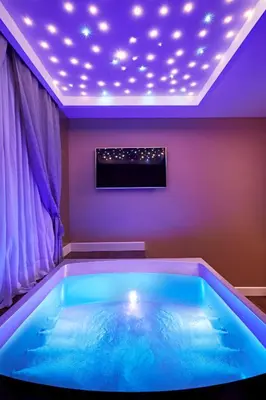 a large blue tub in a room with lights at LE RÊVE DE NAIM Roma in Rome