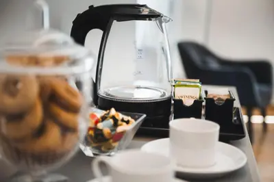a coffee maker and a bowl of food on a table at Mascherino Suites in Rome