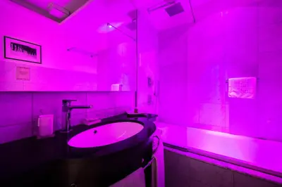 a pink bathroom with a sink and a mirror at Mascherino Suites in Rome