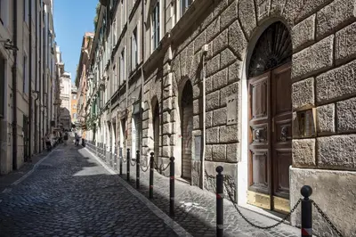 an alley with a large wooden door on a building at Frankie Charme in Rome