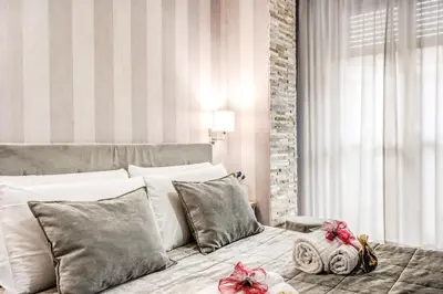 a bedroom with a bed with bows on it at Santamaria Inn in Rome
